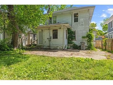View of the home's backyard with a concrete patio and grassy area at 3134 N College Ave, Indianapolis, IN 46205