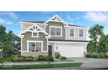 Charming two-story home with craftsman-style details, a two-car garage, and a professionally landscaped front yard at 3200 Glasgow Pl, Danville, IN 46122