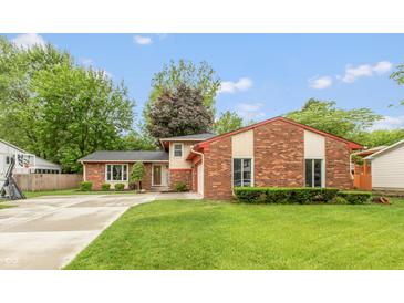 Charming front exterior showcasing a well-manicured lawn and brick facade, with a basketball hoop on the side at 3514 Summerfield Dr, Indianapolis, IN 46214