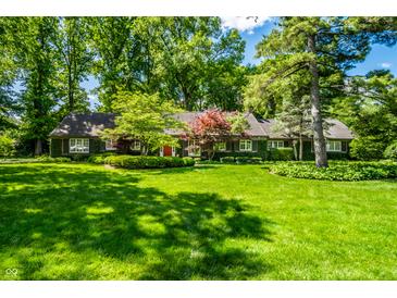 Beautiful single story home with mature trees and lush green lawn at 9550 Copley Dr, Indianapolis, IN 46260