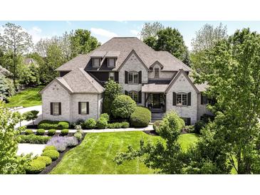 Charming brick home with a lush green lawn and mature landscaping, offering great curb appeal at 13909 Waterway Blvd, Fishers, IN 46040