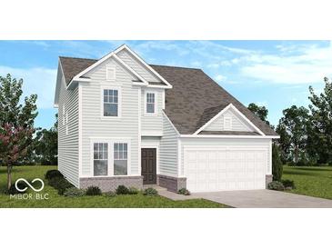 Charming two-story home with a two car garage, a manicured lawn, and light blue siding at 1961 Black Oak Dr, Shelbyville, IN 46176