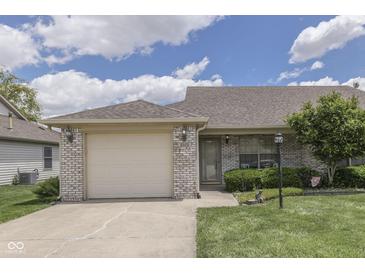 Charming home featuring a well-manicured lawn, a one-car garage, and classic brick facade at 2025 Flamingo Way, Franklin, IN 46131