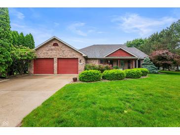 Charming brick ranch home with attached two-car garage and well-manicured lawn at 2027 Round Barn Ct, Anderson, IN 46017