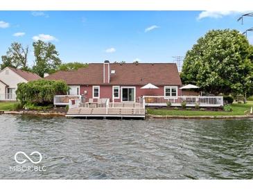 The back of the house has a large yard with a pier and easy access to the lake at 3403 Island Way, Indianapolis, IN 46214