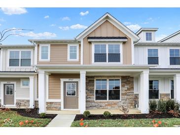Inviting two-story home with a covered front porch, stone accents, and manicured landscaping at 3927 Wren Dr, Brownsburg, IN 46112