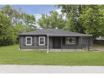 Charming single-story home with a well-manicured lawn and gray siding at 625 E 106Th St, Carmel, IN 46280