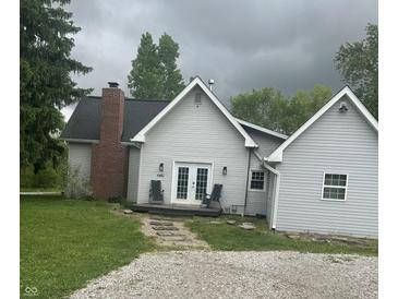Charming single-story house featuring a brick chimney and a cozy front porch with seating at 6450 N State Road 75, North Salem, IN 46165