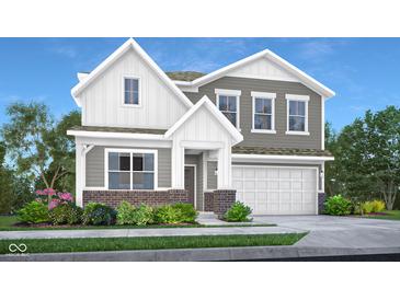 Charming two-story home boasts a two-car garage and a beautifully landscaped front yard with flowering bushes at 8856 Alexander Ridge Dr, McCordsville, IN 46055