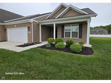 Charming single-story brick home with manicured lawn, covered entry, and attached garage at 9106 Hedley E Way, Avon, IN 46123