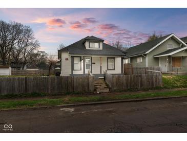 Charming home featuring a fenced yard, neutral paint and inviting curb appeal at 1216 N Ewing St, Indianapolis, IN 46201