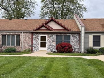 Charming exterior of a well-maintained home with stone facade and a professionally landscaped front yard at 1711 Lafayette Ave # 7, Lebanon, IN 46052
