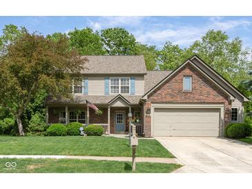 Charming two-story home with brick accents, attached garage and well-manicured lawn at 18278 Benton Oak Dr, Noblesville, IN 46062