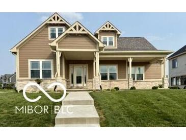 Charming home with a covered front porch and beautifully landscaped front yard at 217 N Liberty Blvd, Mooresville, IN 46158