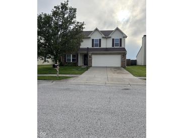 Traditional two-story home with a well-manicured lawn, two-car garage, and basketball hoop in the driveway at 2730 Foxbriar Pl, Indianapolis, IN 46203