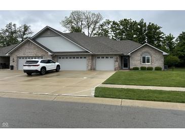 Charming single-story home with a brick facade, three-car garage, and well-manicured lawn at 308 Bay Ridge Dr, Pendleton, IN 46064