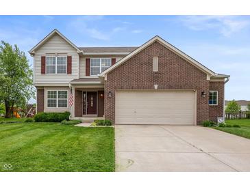 Inviting two-story home featuring a brick facade, attached two-car garage, and well-manicured lawn at 3638 Fieldstone Ln, Plainfield, IN 46168