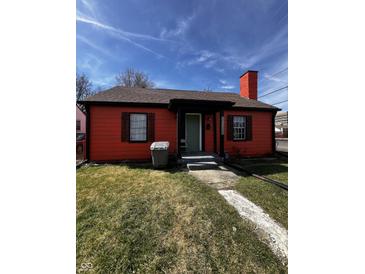 Charming orange single-story home featuring a welcoming front porch and well-maintained front yard at 3752 N Oxford St, Indianapolis, IN 46218