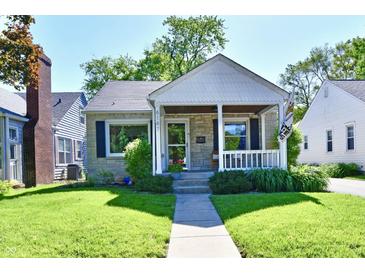 Charming single-Gathering home with stone accents, covered porch, and well-manicured lawn at 6187 Crittenden Ave, Indianapolis, IN 46220