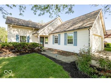 Charming home featuring blue shutters, a well-maintained lawn, and landscaped garden beds at 7650 Micawber Ct, Indianapolis, IN 46256