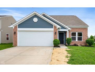 Charming single-story brick home with a two-car garage and manicured front lawn at 7918 Wolfgang Pl, Indianapolis, IN 46239