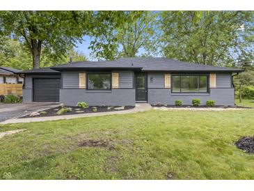 Charming grey ranch home with black trim, attached garage, and a nicely landscaped front yard at 8933 W 1050 S, Fortville, IN 46040