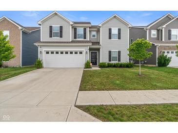 Two-story home with gray siding, black shutters, a two car garage and a well manicured front yard at 918 Cass Dr, Franklin, IN 46131