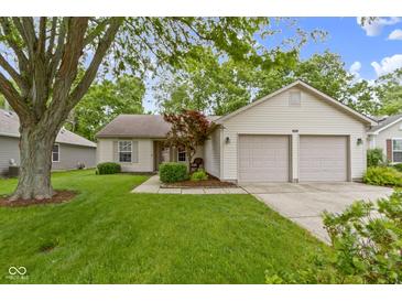 Charming single-story home featuring a manicured lawn, two-car garage, and inviting curb appeal at 975 Atir Ln, Greenfield, IN 46140