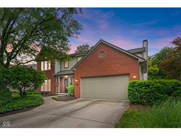 Charming two-story home featuring a brick facade, attached garage, and beautifully landscaped front yard at 10501 Greenway Dr, Fishers, IN 46037