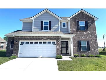 Charming two-story home featuring a brick and vinyl facade, attached garage, and well-maintained landscaping at 1056 Bent Branch Ln, Greenwood, IN 46143