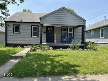 Charming one-story home featuring a welcoming front porch and well-maintained landscaping at 1722 Dawson St, Indianapolis, IN 46203