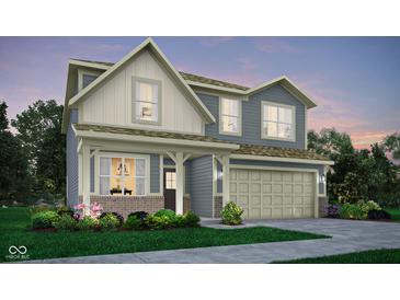Inviting two-story home with a neutral color palette, two-car garage, well-manicured landscaping, and charming front porch at 19831 Moorpark Lndg, Noblesville, IN 46062