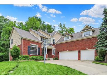 Beautiful two-story brick home featuring a spacious driveway and manicured lawn with a basketball hoop at 2592 Highmount Ct, Carmel, IN 46033