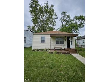 Charming bungalow featuring a well-maintained lawn, landscaped flower bed, and cozy front porch at 3305 E 30Th St, Indianapolis, IN 46218