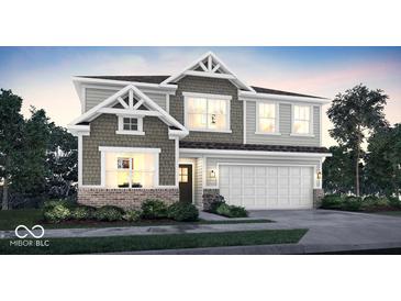 Charming two-story home with stone accents, a two-car garage and well manicured landscaping in a desirable neighborhood at 3449 Glasgow Pl, Danville, IN 46122