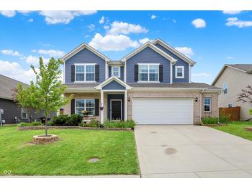 Charming two-story home featuring blue siding, brick accents, manicured lawn, and an attached two-car garage at 442 Mozart Dr, Greenfield, IN 46140