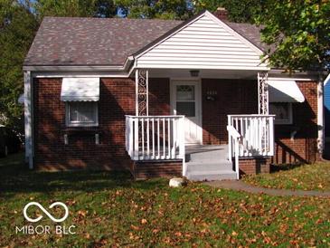 Charming one-story brick home with a covered front porch and tidy landscaping at 4830 Wentworth Blvd, Indianapolis, IN 46201