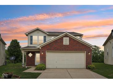 Charming two-story home with a brick facade, inviting entrance, and attached two-car garage at 513 Sun Catcher Dr, Avon, IN 46123