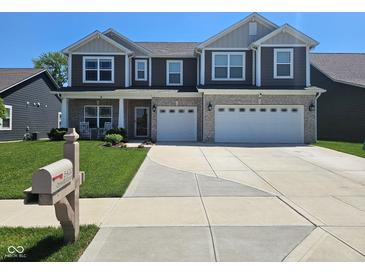 Beautiful two-story home featuring a manicured lawn, stone accents, and a two-car garage at 5420 Orwell Ct, Indianapolis, IN 46239