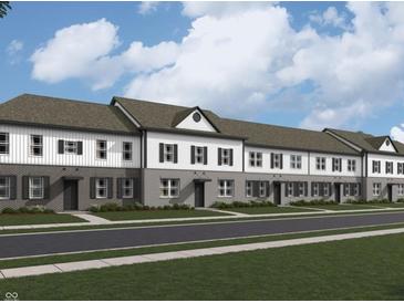Charming townhome featuring a neutral brick and white siding exterior with black shutters and modern design elements at 6248 Cascades Dr, Whitestown, IN 46075