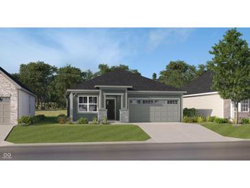 Charming single-story home with a two-car garage, gray siding, stone accents and a well-manicured lawn at 633 Bridgeman Rd, Avon, IN 46123