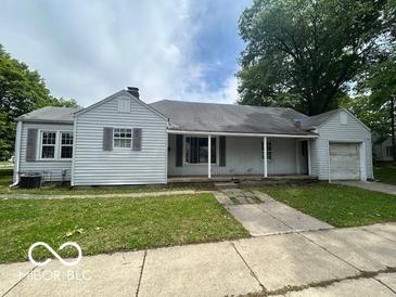 Classic single-story home with covered porch, lawn, and attached one-car garage at 7607 E 46Th St, Indianapolis, IN 46226