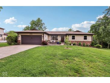 Charming single-story home with a manicured lawn, attached garage, and lovely landscaping at 976 Santa Maria Dr, Greenwood, IN 46143