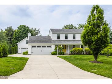 Charming two-story home featuring a covered porch, well-maintained lawn, and a convenient two-car garage at 10833 Marquette Rd, Zionsville, IN 46077