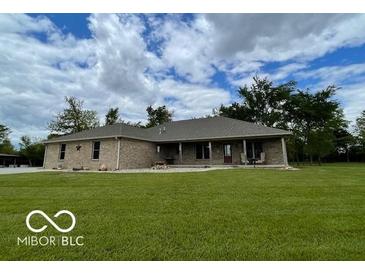 Charming single-story brick home with a lush green lawn and ample space at 11898 N 200 W, Fountaintown, IN 46130
