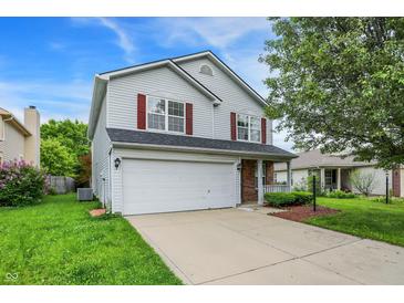 Charming two-story home with a well-maintained lawn, two car garage, and beautiful landscaping at 15264 Ten Point Dr, Noblesville, IN 46060
