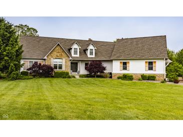 Charming home featuring a stone facade, dormer windows, and a well-manicured lawn at 1820 N 1100 E, Sheridan, IN 46069