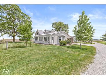 Charming home featuring a sunroom, well-maintained lawn, and mature trees at 20530 Victory Chapel Rd, Noblesville, IN 46060