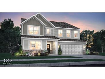 Charming two-story home featuring board and batten siding, a two-car garage, and professionally landscaped yard at 3080 Glasgow Pl, Danville, IN 46122