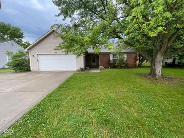 Charming home featuring a well-manicured lawn, brick accents, an attached garage, and mature trees at 356 Seabreeze Cir, Avon, IN 46123